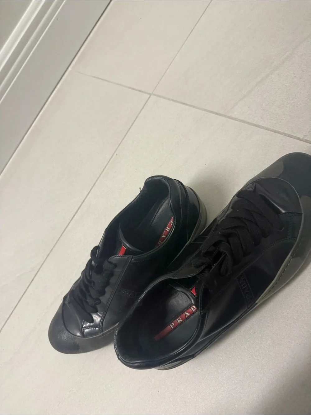 Prada Black Low-Top Leather Sneaker with Red Tongue Accent